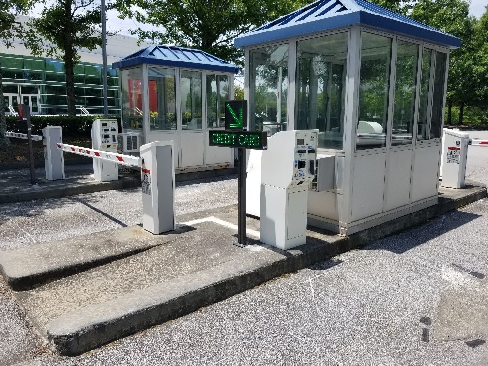 A parking lot with a green sign that says credit card