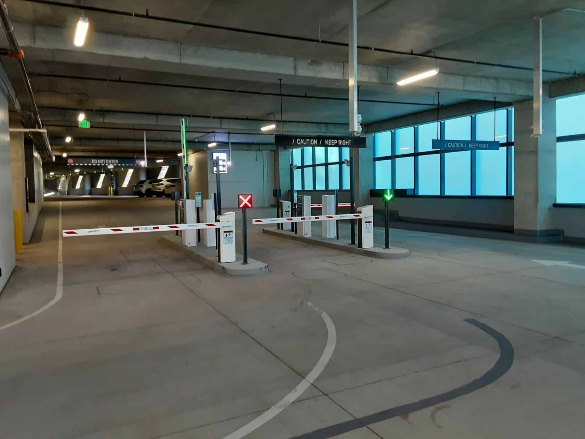 A parking garage with a lot of barriers and gates