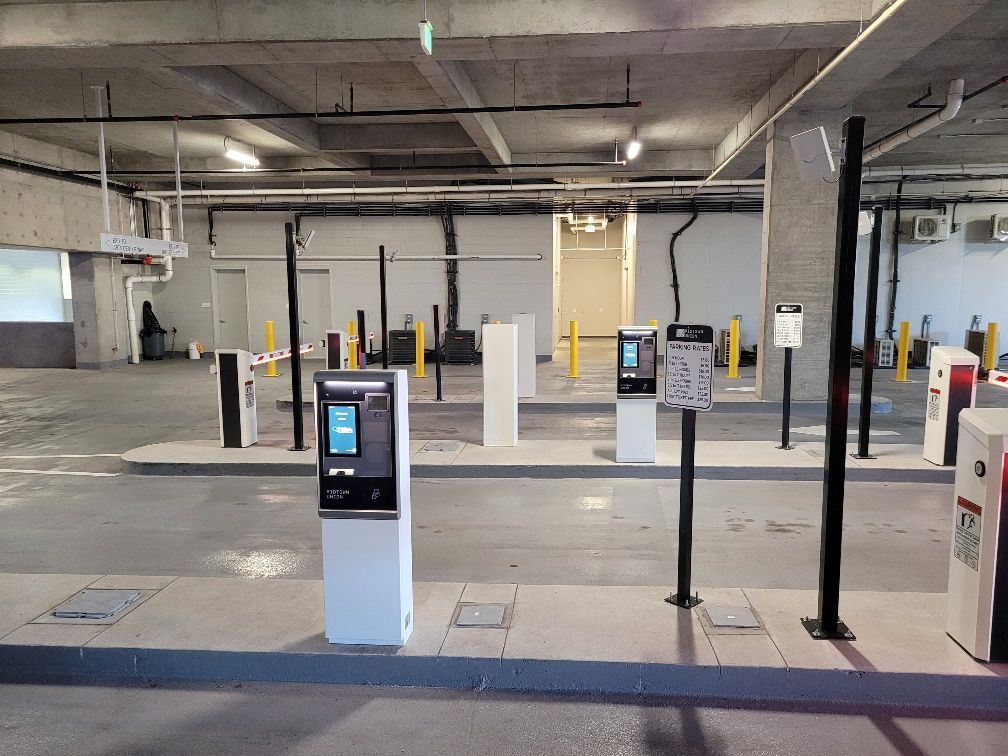 A parking garage with a lot of parking meters