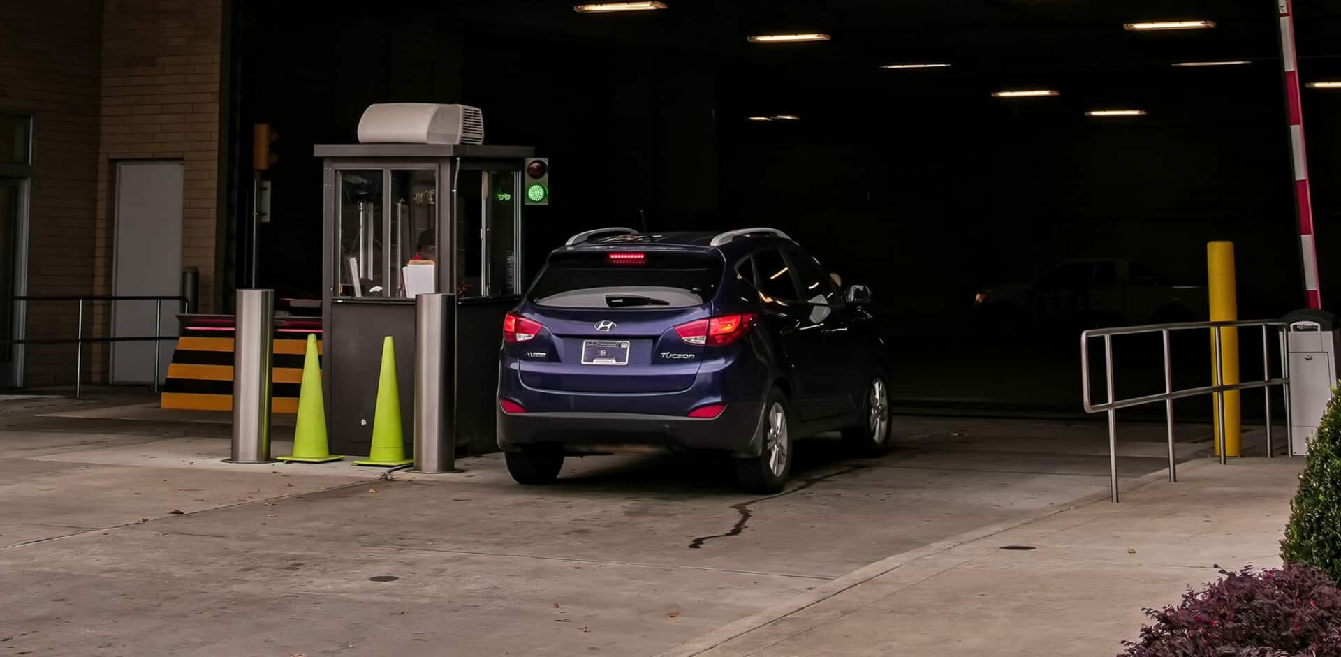 A blue suv is parked in a parking garage.