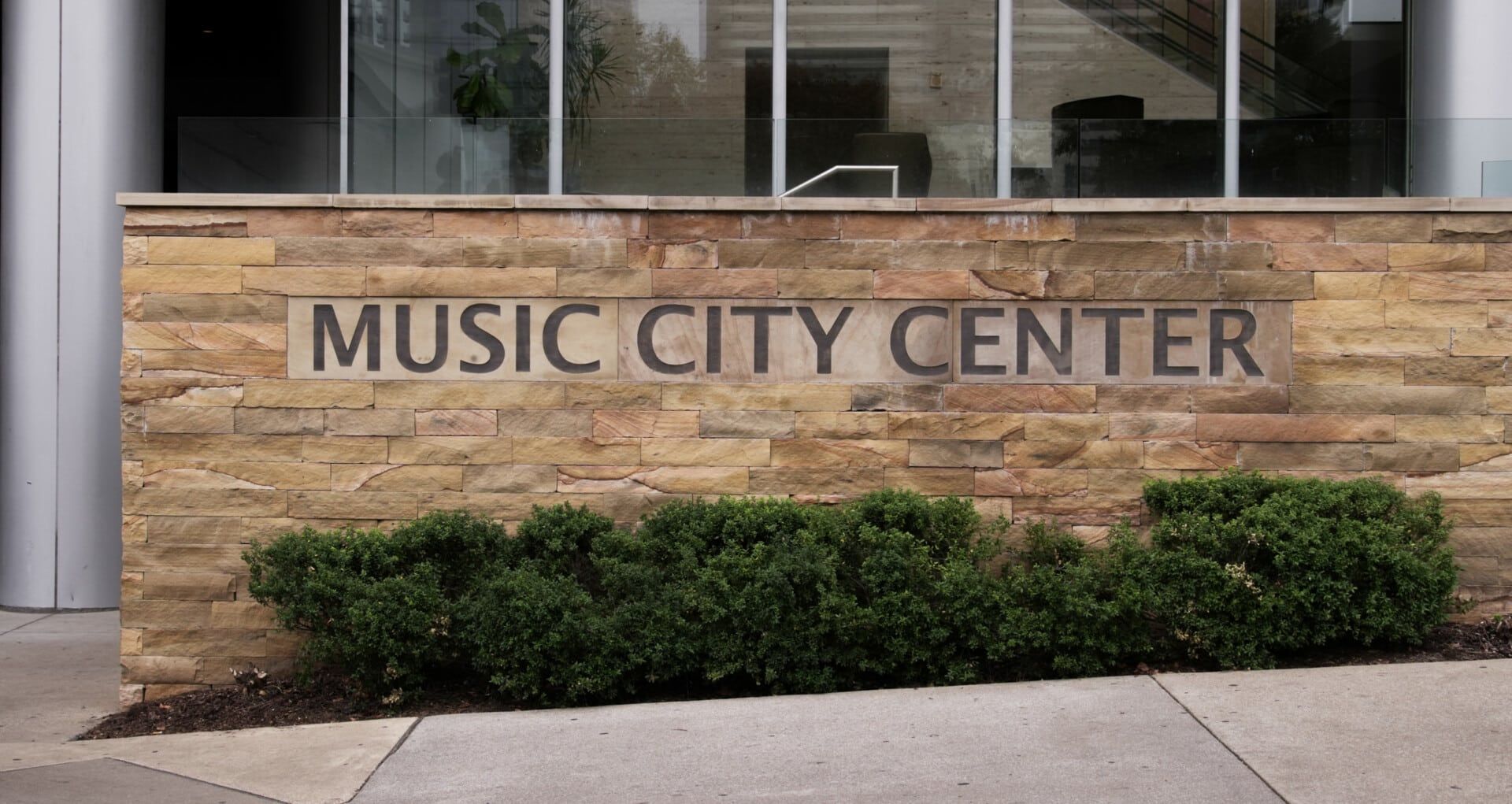 A stone wall with the words music city center on it