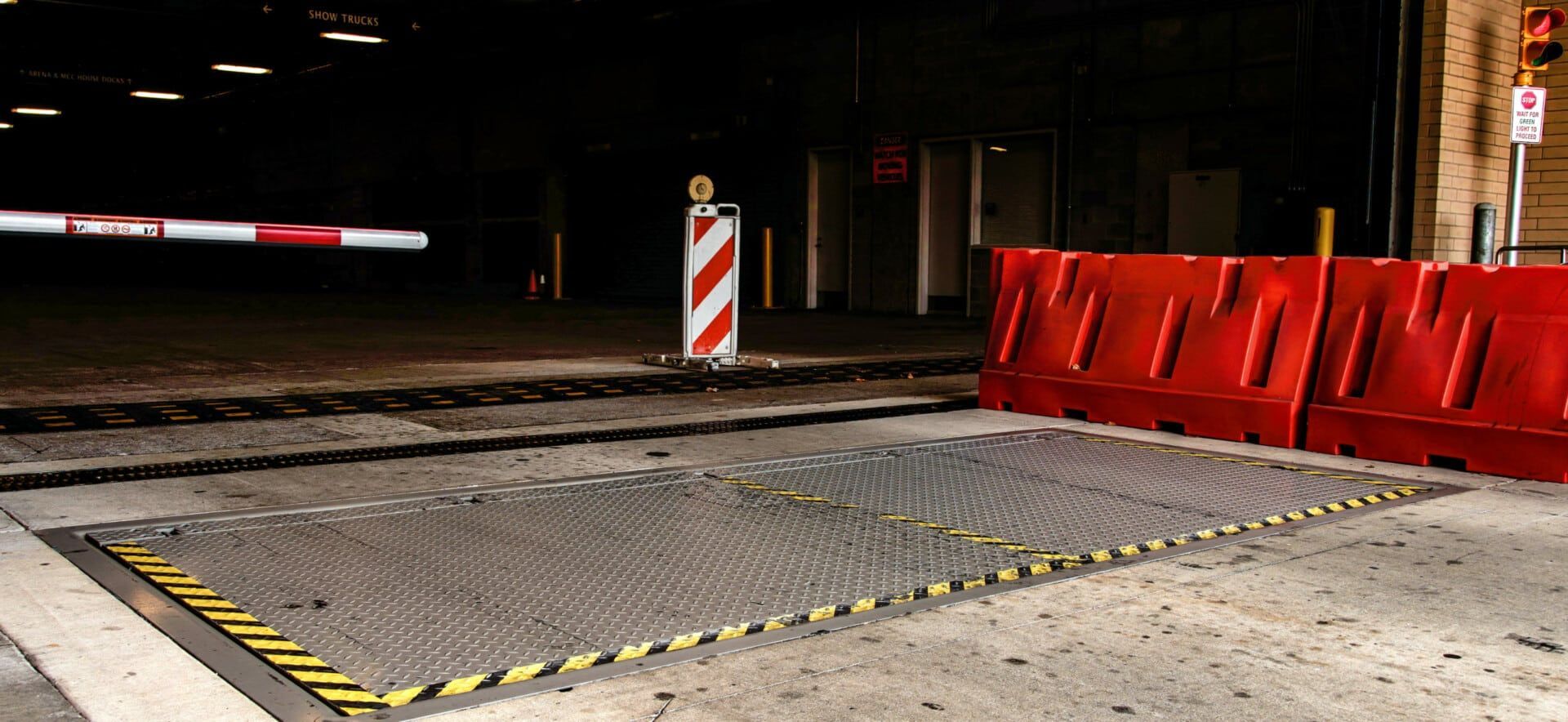 A red barrier is blocking the entrance to a parking garage.