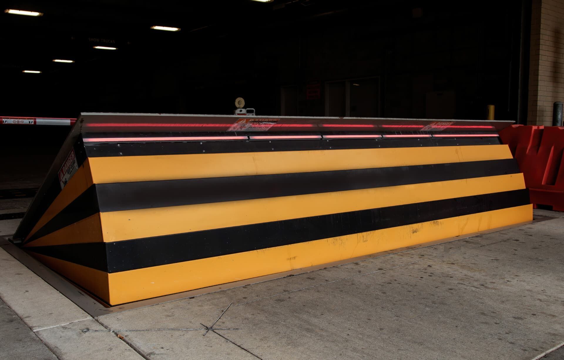 A black and yellow striped block on the sidewalk