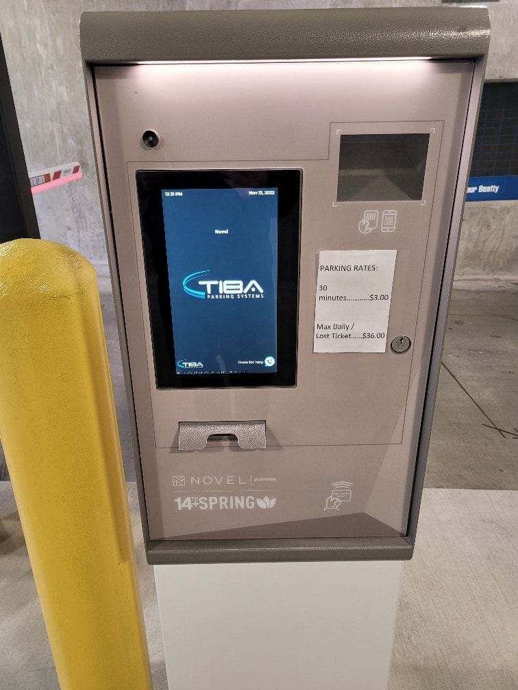 A parking meter with a screen that says tba on it