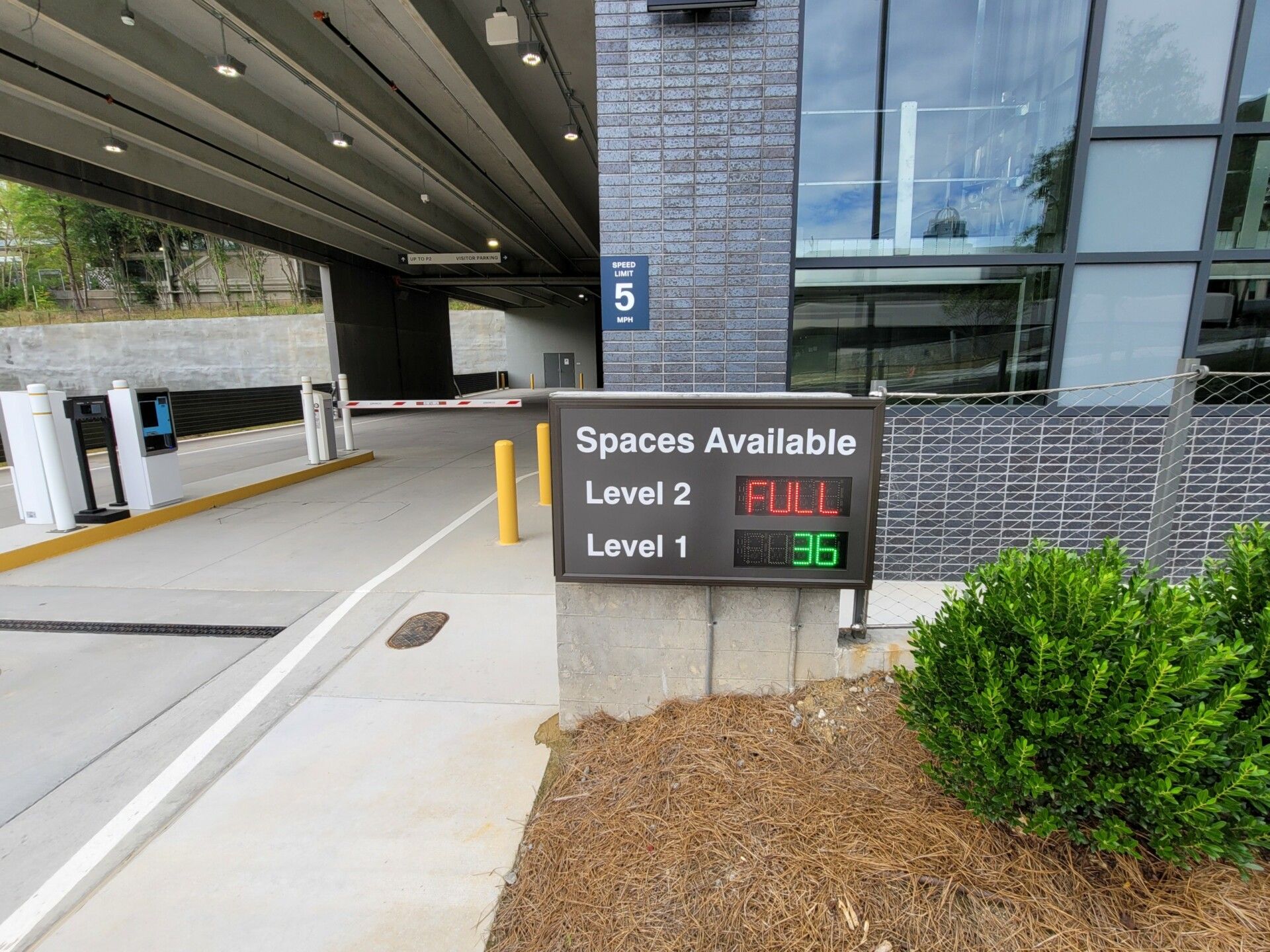 A parking garage with a sign that says spaces available