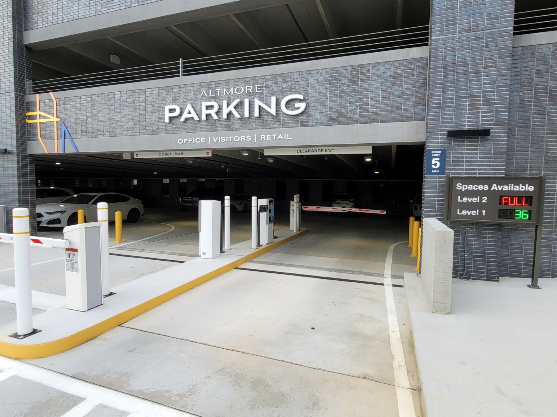 A parking garage with cars parked inside of it