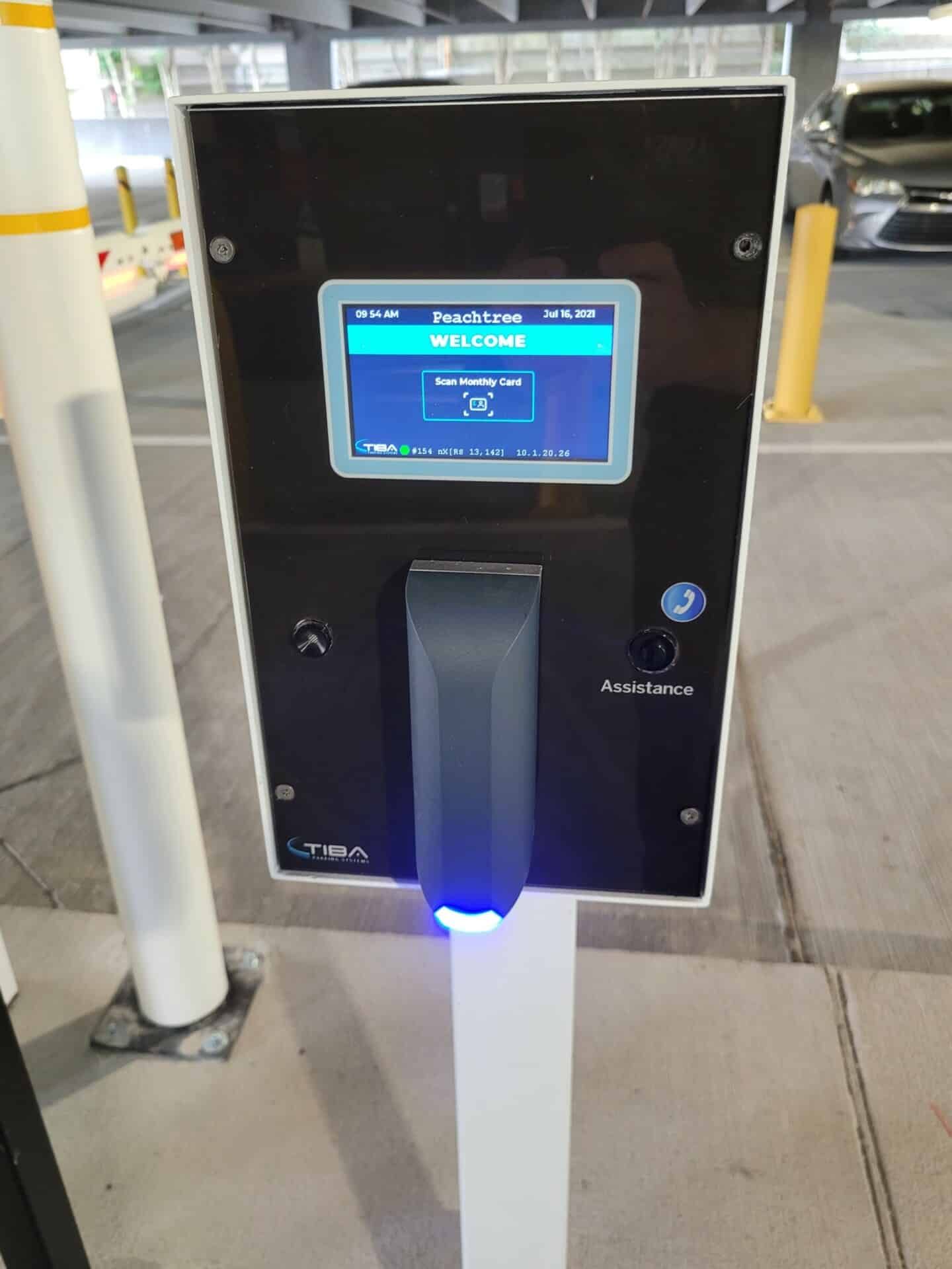A parking meter with a screen that says welcome on it
