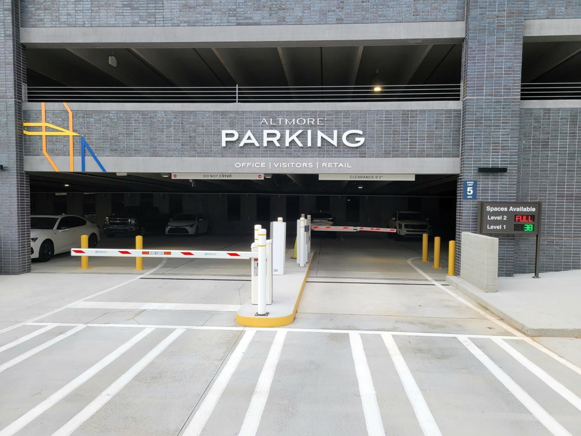 A parking garage with cars parked inside of it