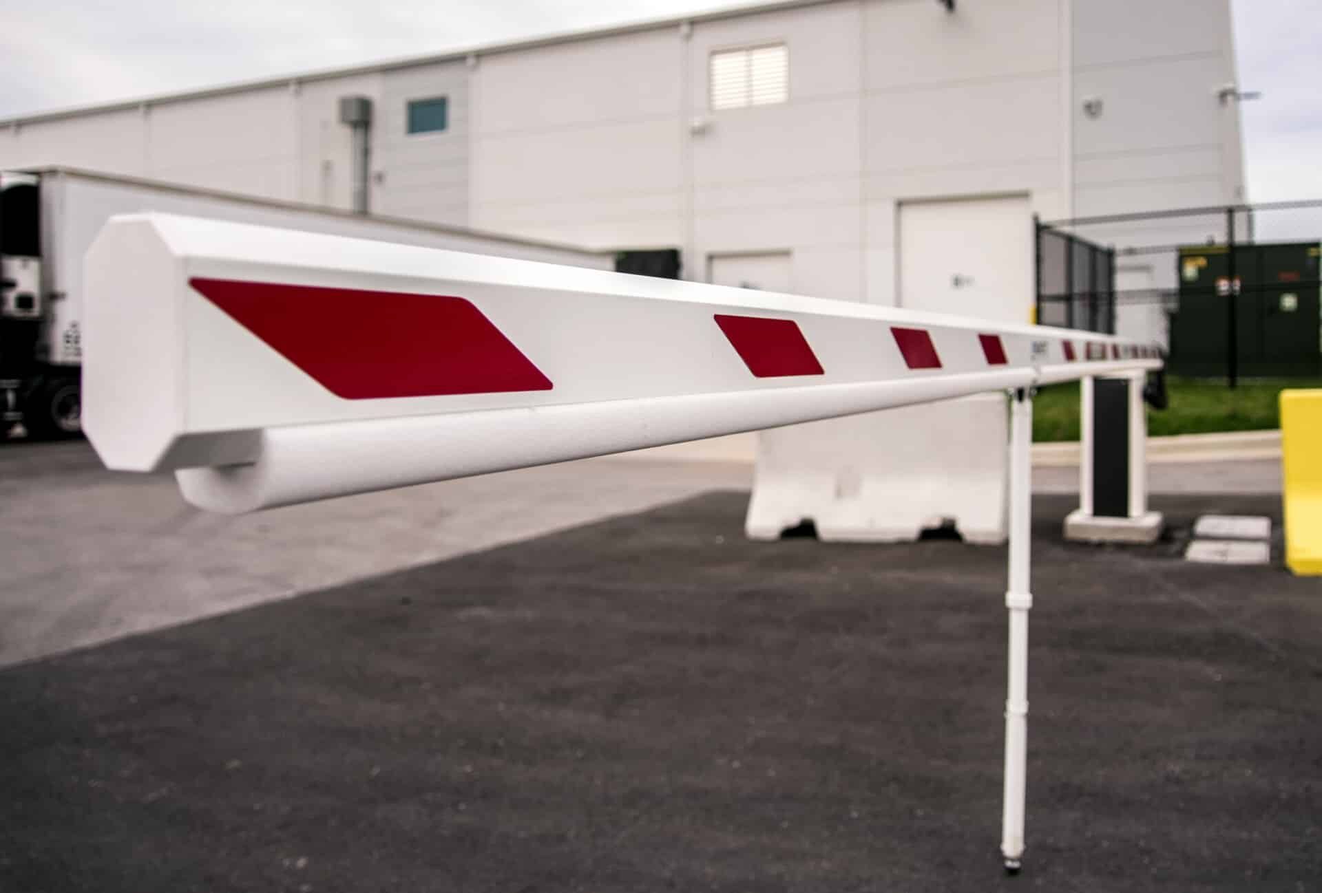 A white and red barrier is sitting in front of a building
