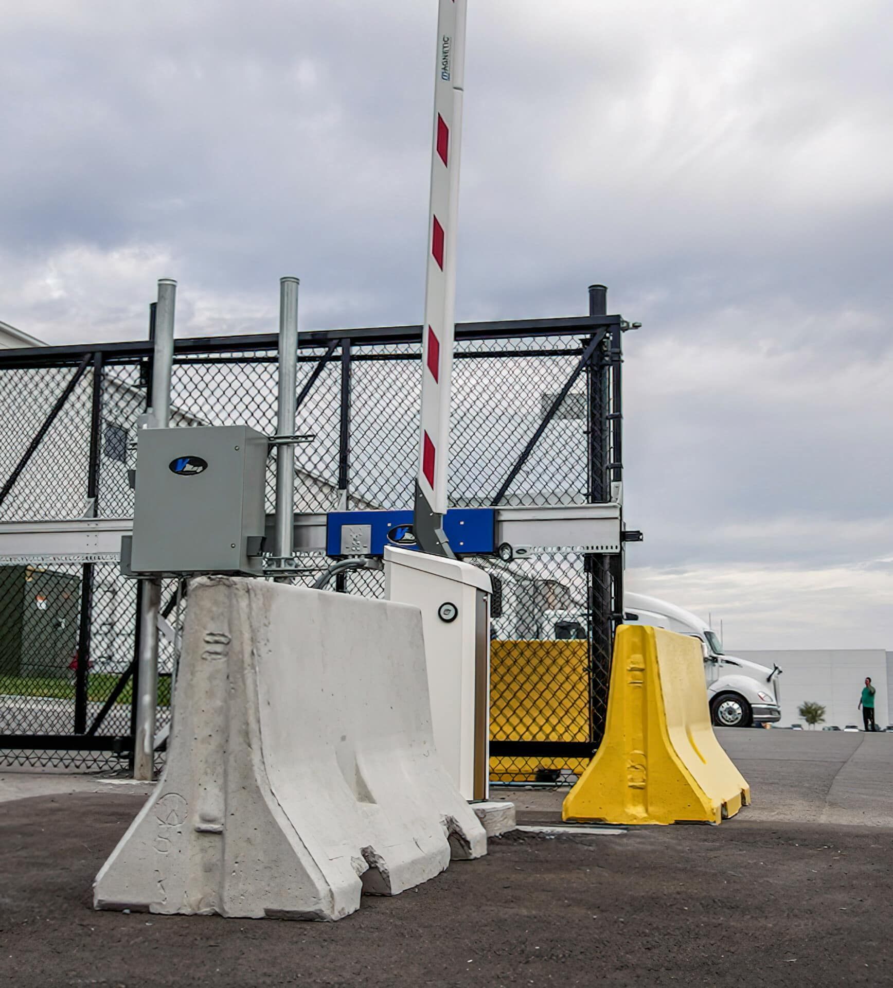 A concrete barrier is sitting in front of a gate