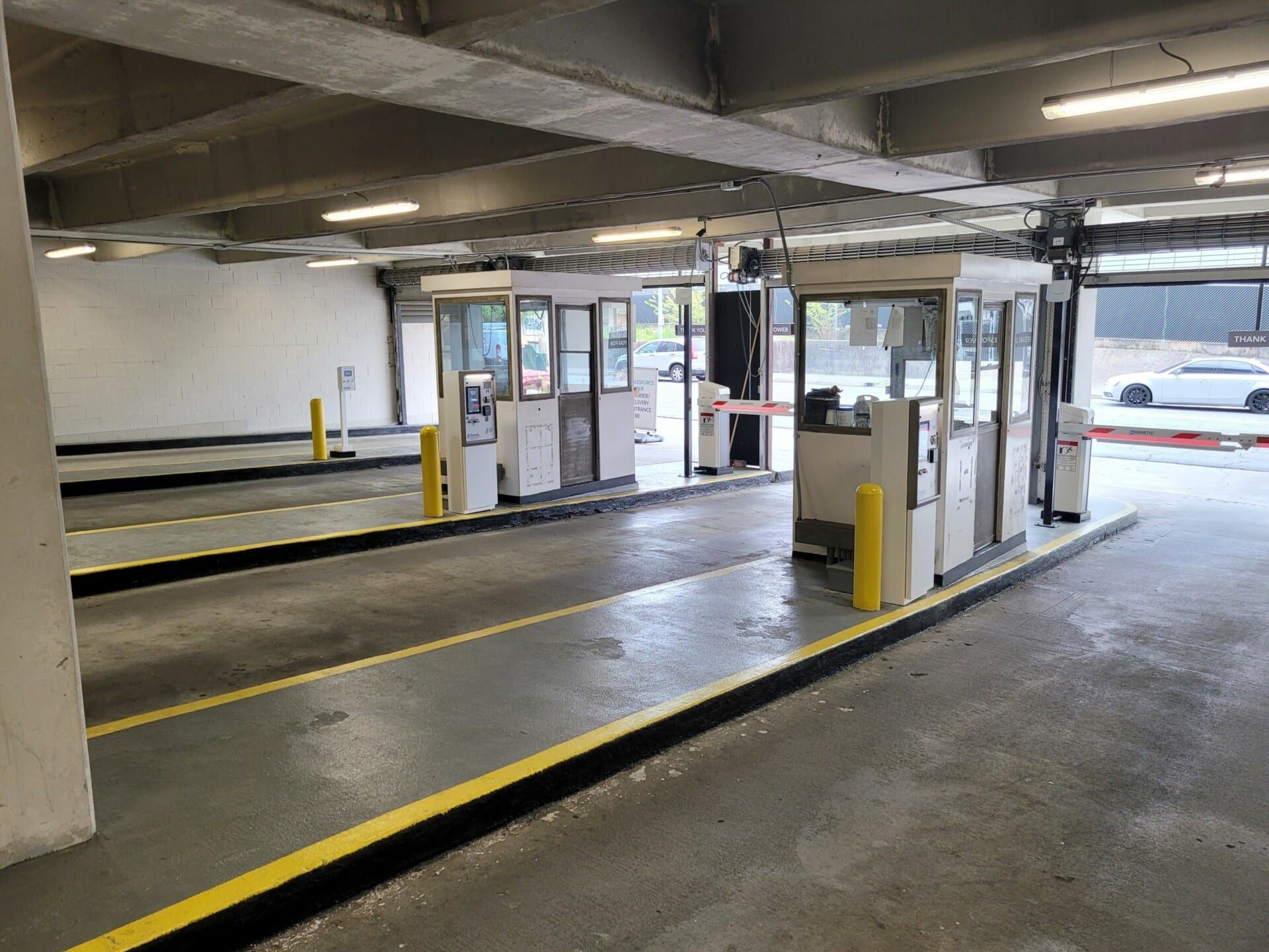 A parking garage with cars parked in it and a gate.