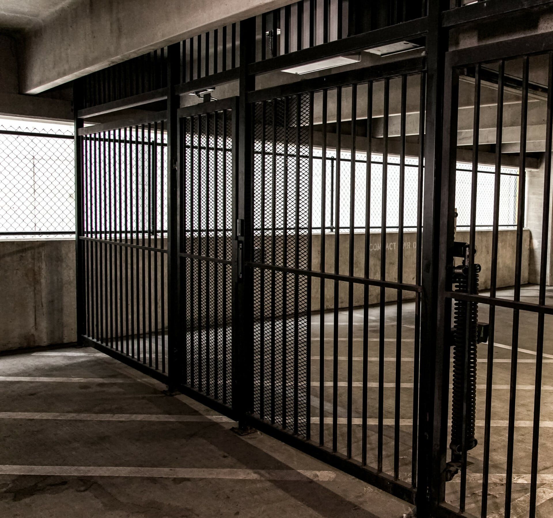 A row of prison bars in a parking garage