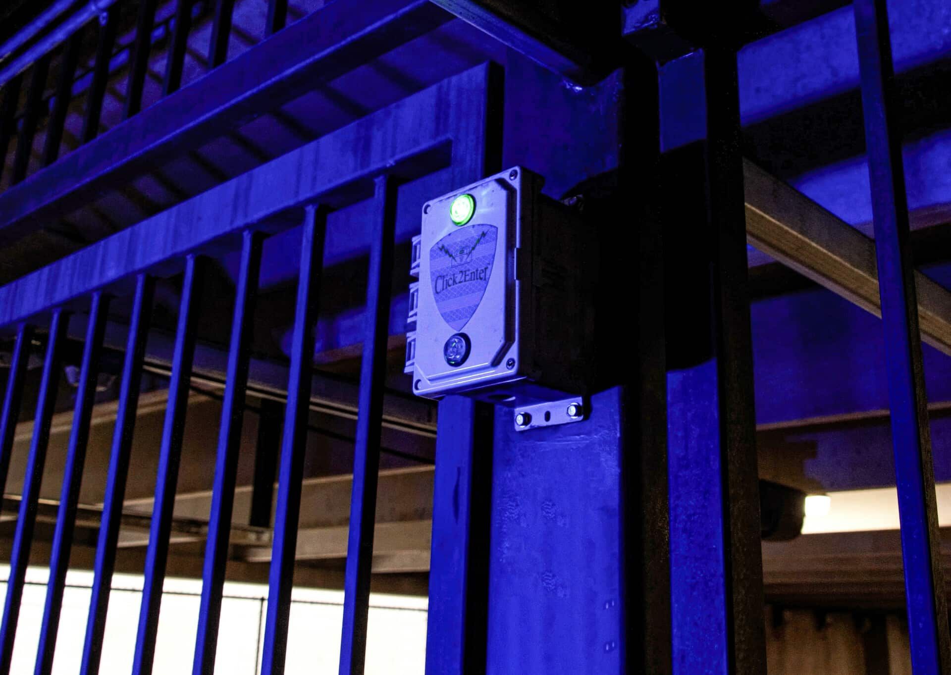 A blue fence with a light on the side of it