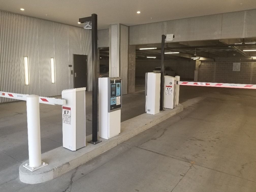 A parking garage with a lot of barriers and gates.