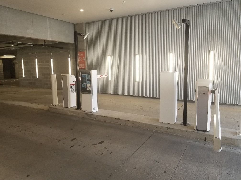 A parking garage with a lot of barriers and lights