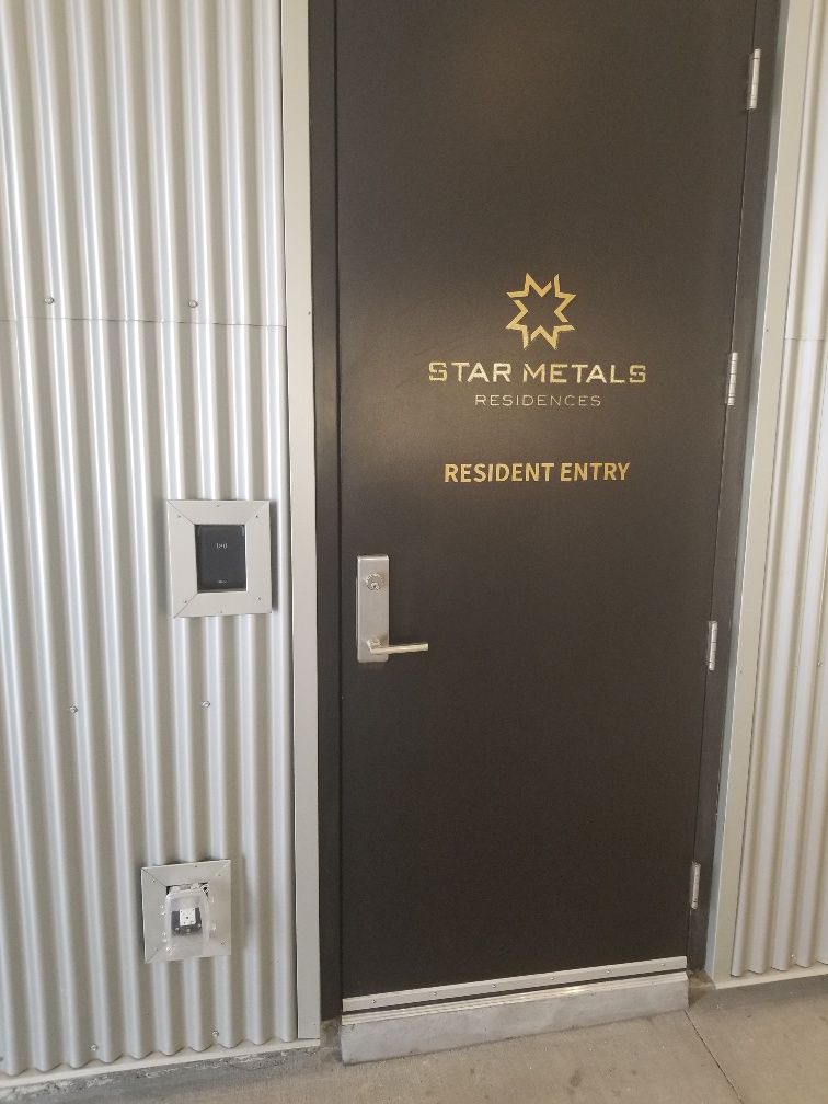 A black door with a star metals logo on it.