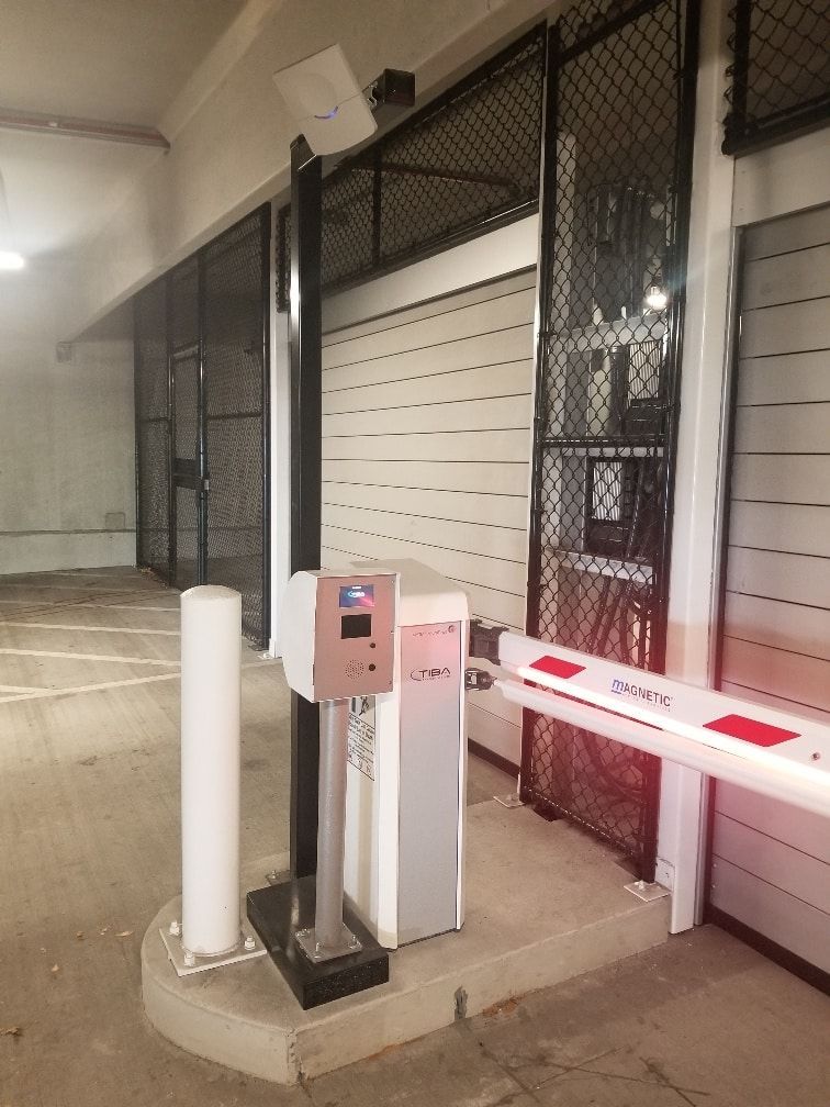 A parking garage with a gate and a barrier.