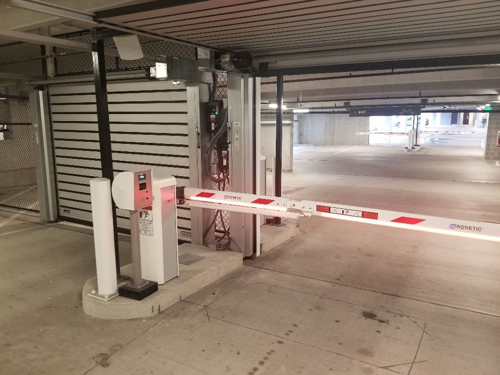 A parking garage with a barrier in the middle of it.