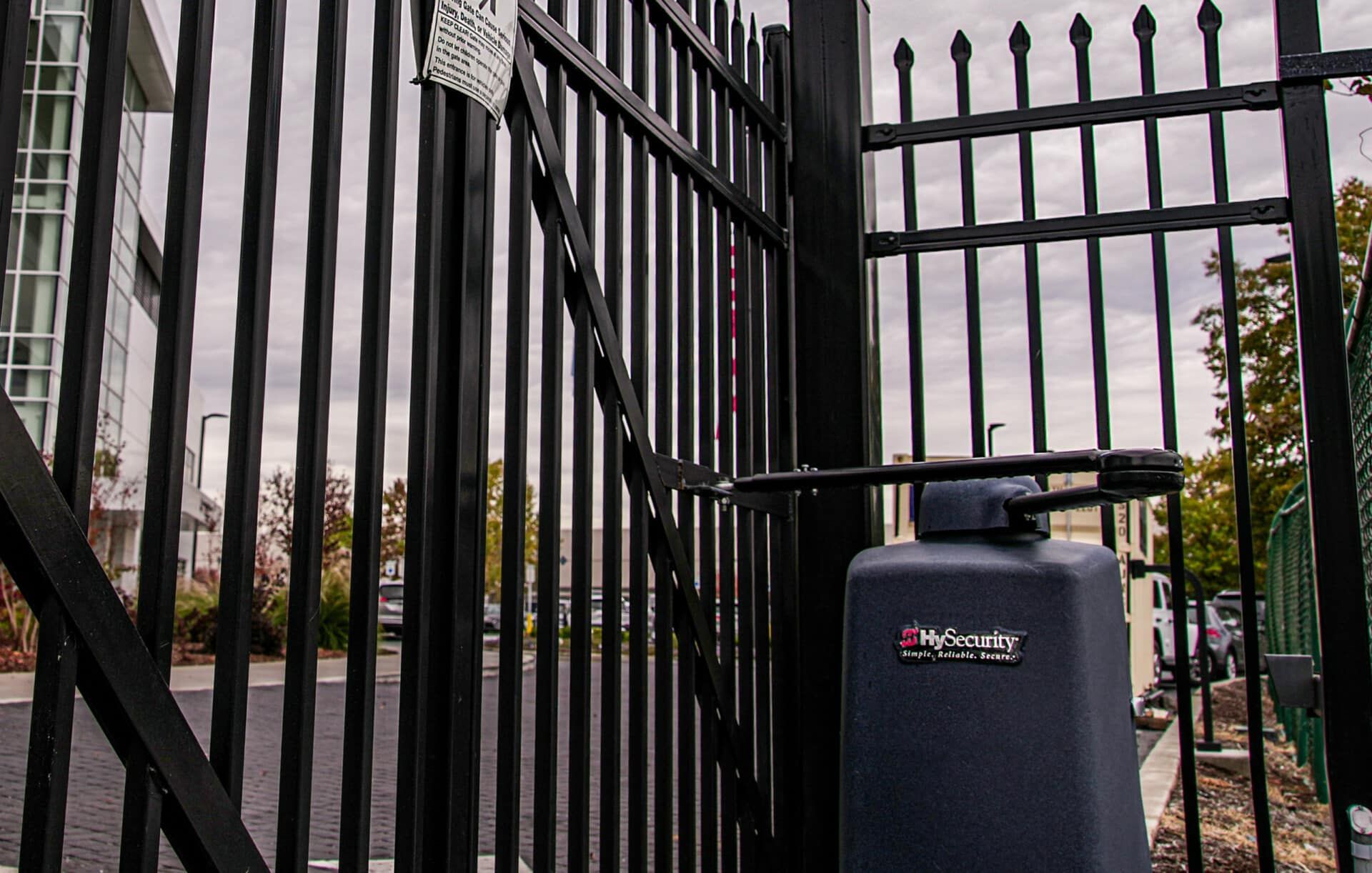 A black gate with a black box in front of it.