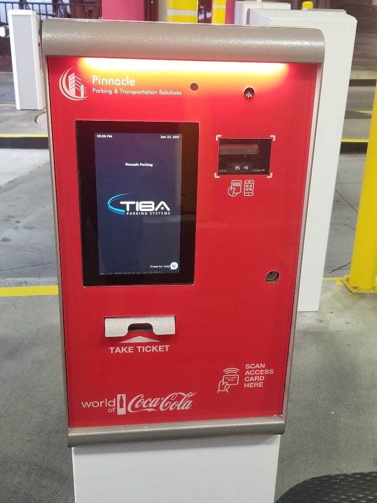 A red machine with coca cola written on it