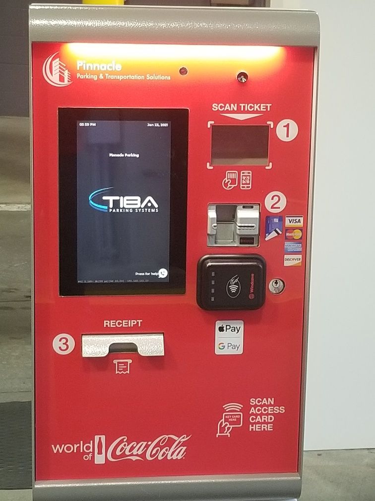 A red coca cola vending machine with a screen
