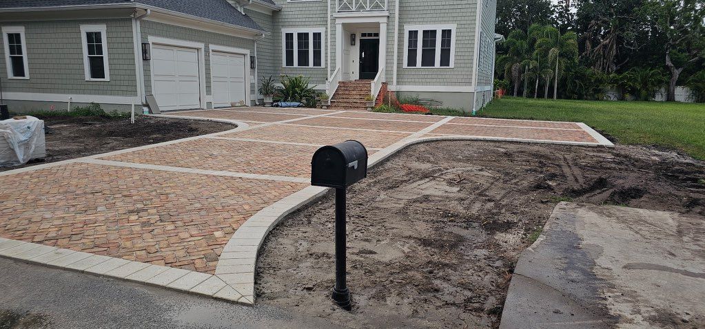 Front yard gravel landscaping with a black mailbox and house in the background