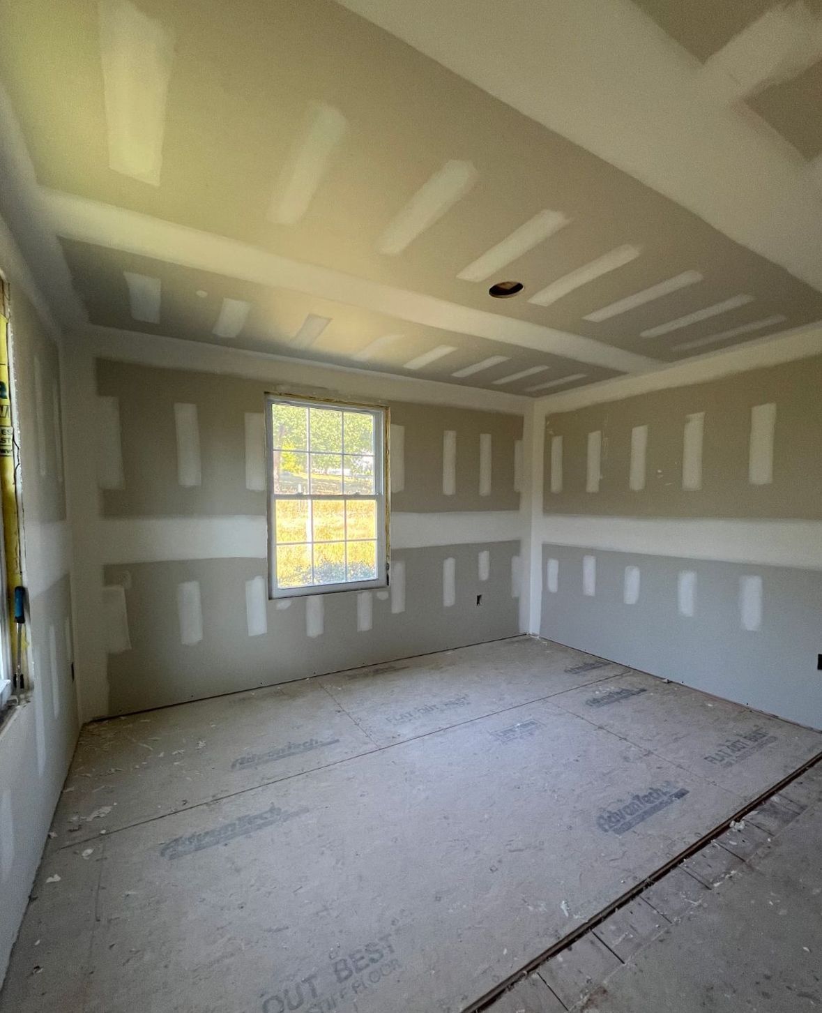 Drywall panels being installed on residential interior walls