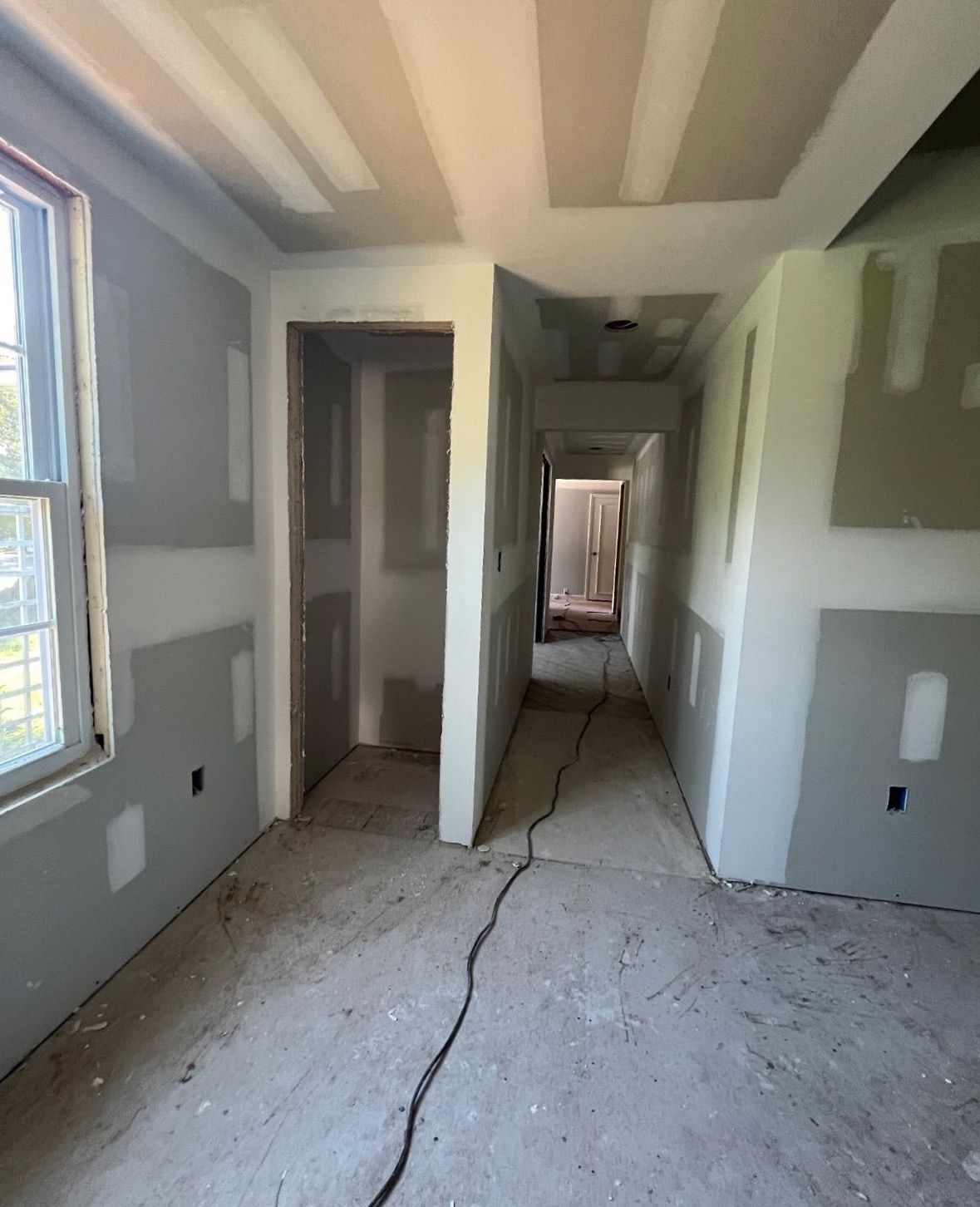 Interior wall framing with newly installed drywall panels