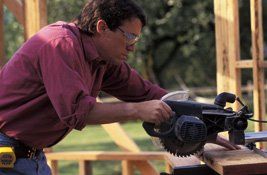 Man using a table saw to cut wood