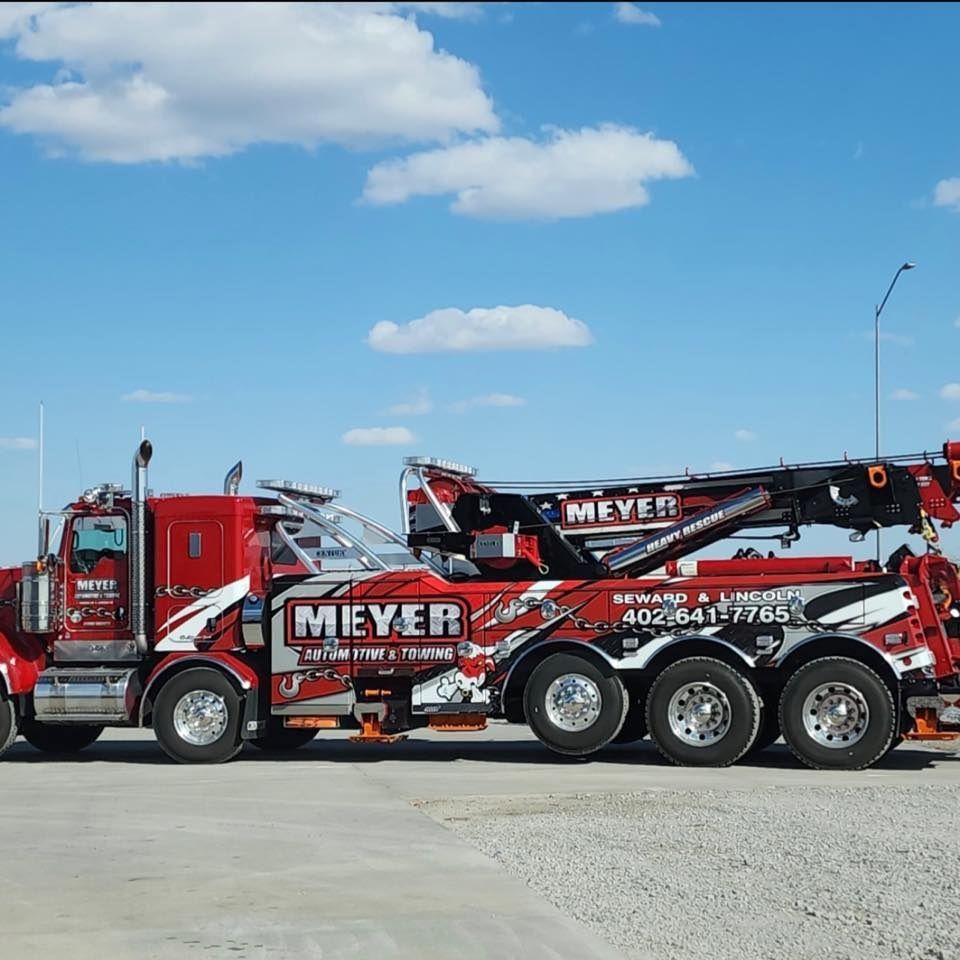 A red tow truck with the word meyer on it