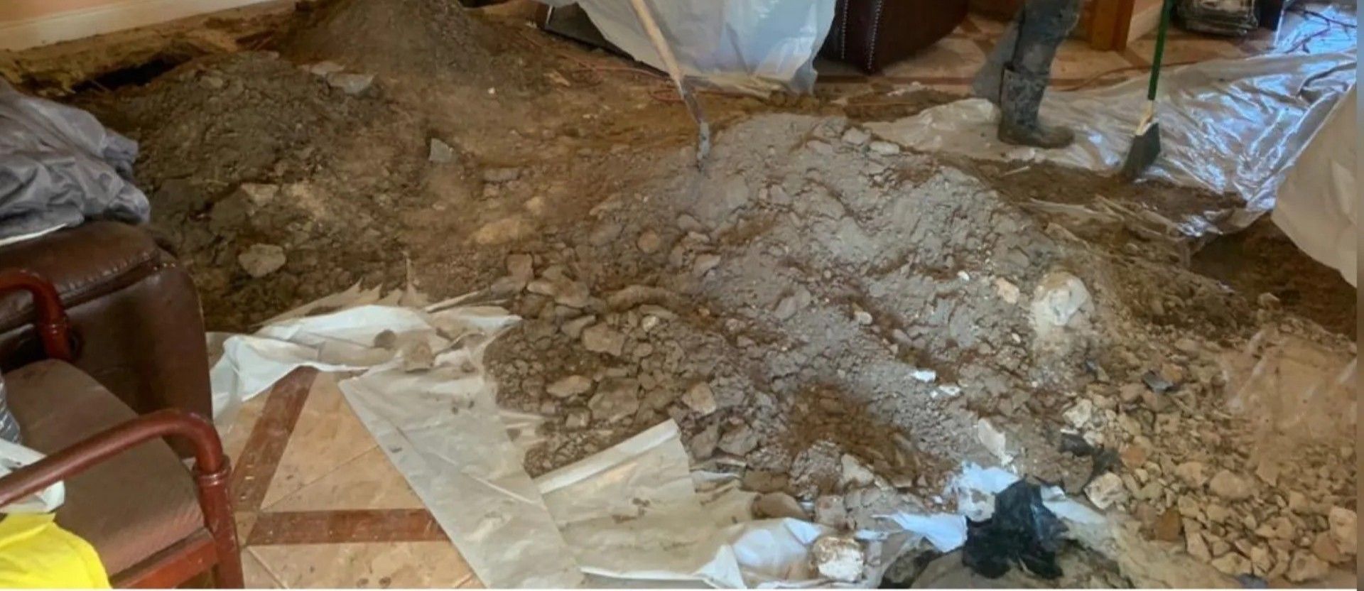 Indoor room with a large pile of dirt and rubble on the floor during cleanup or renovation