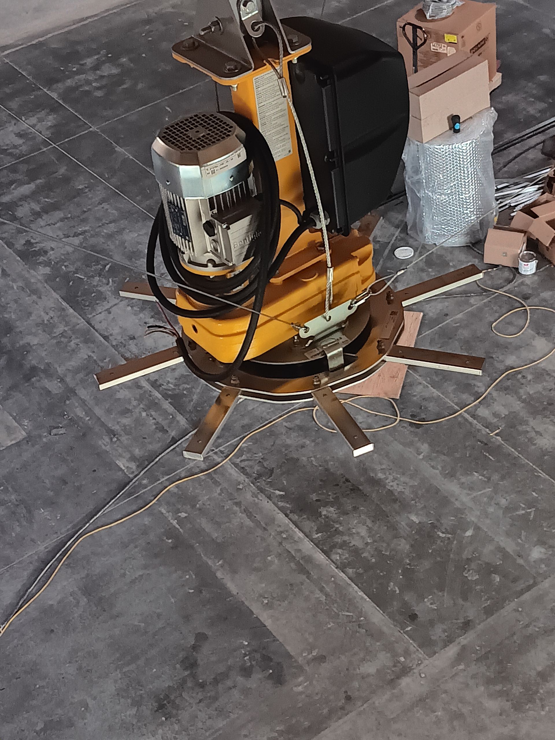 A yellow machine is sitting on a tiled floor