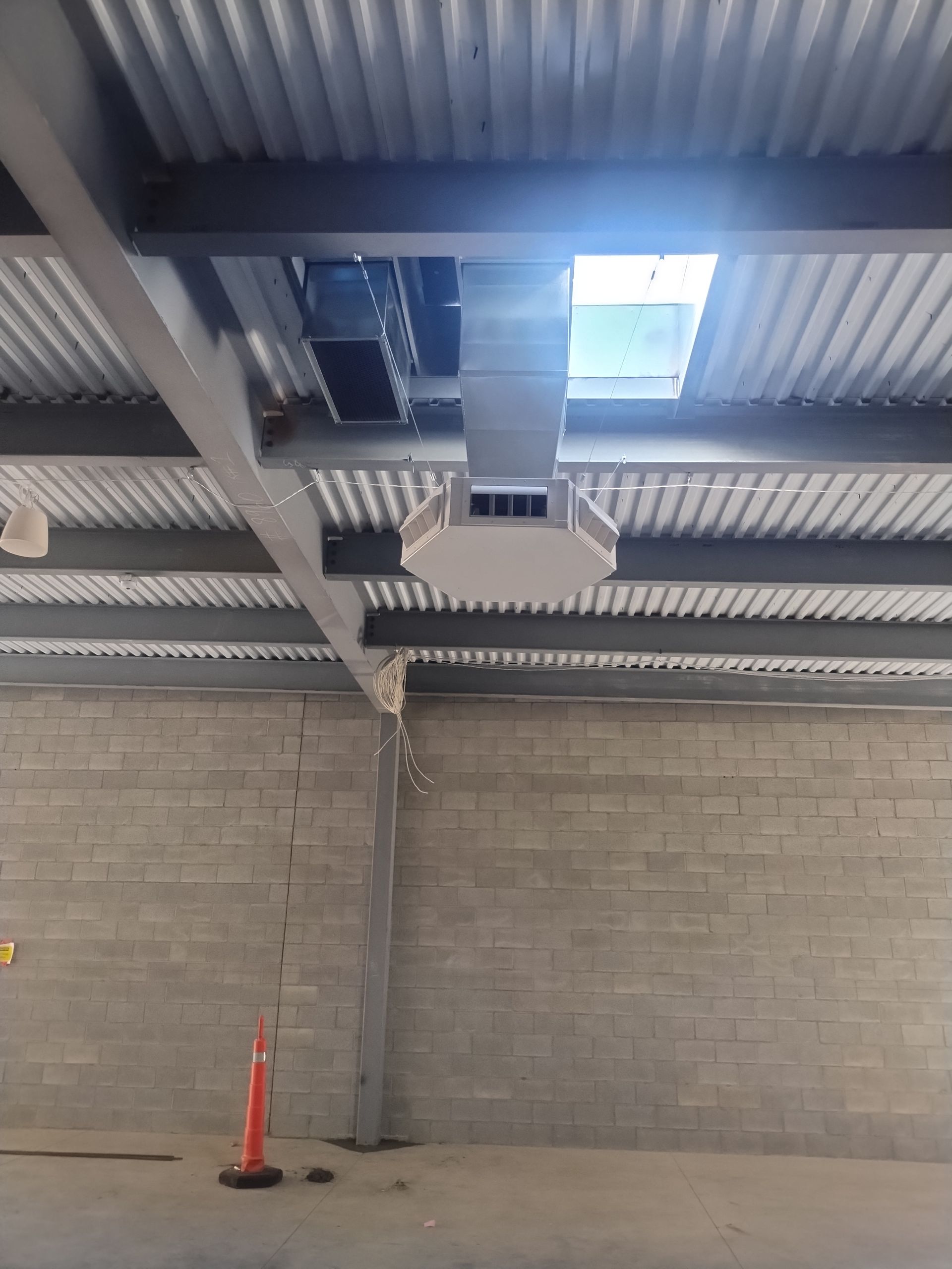The ceiling of a building with a skylight and a ventilation system