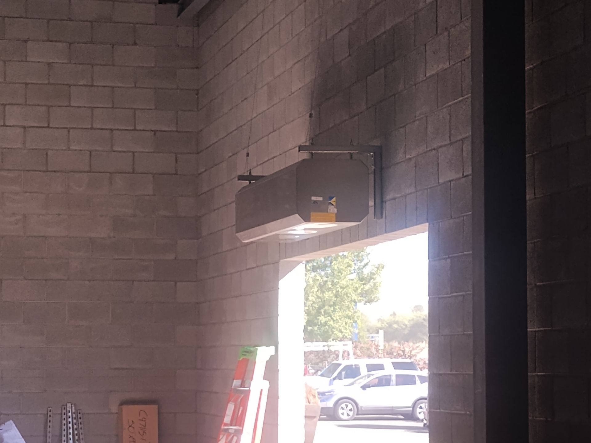 A brick wall with a light hanging from it
