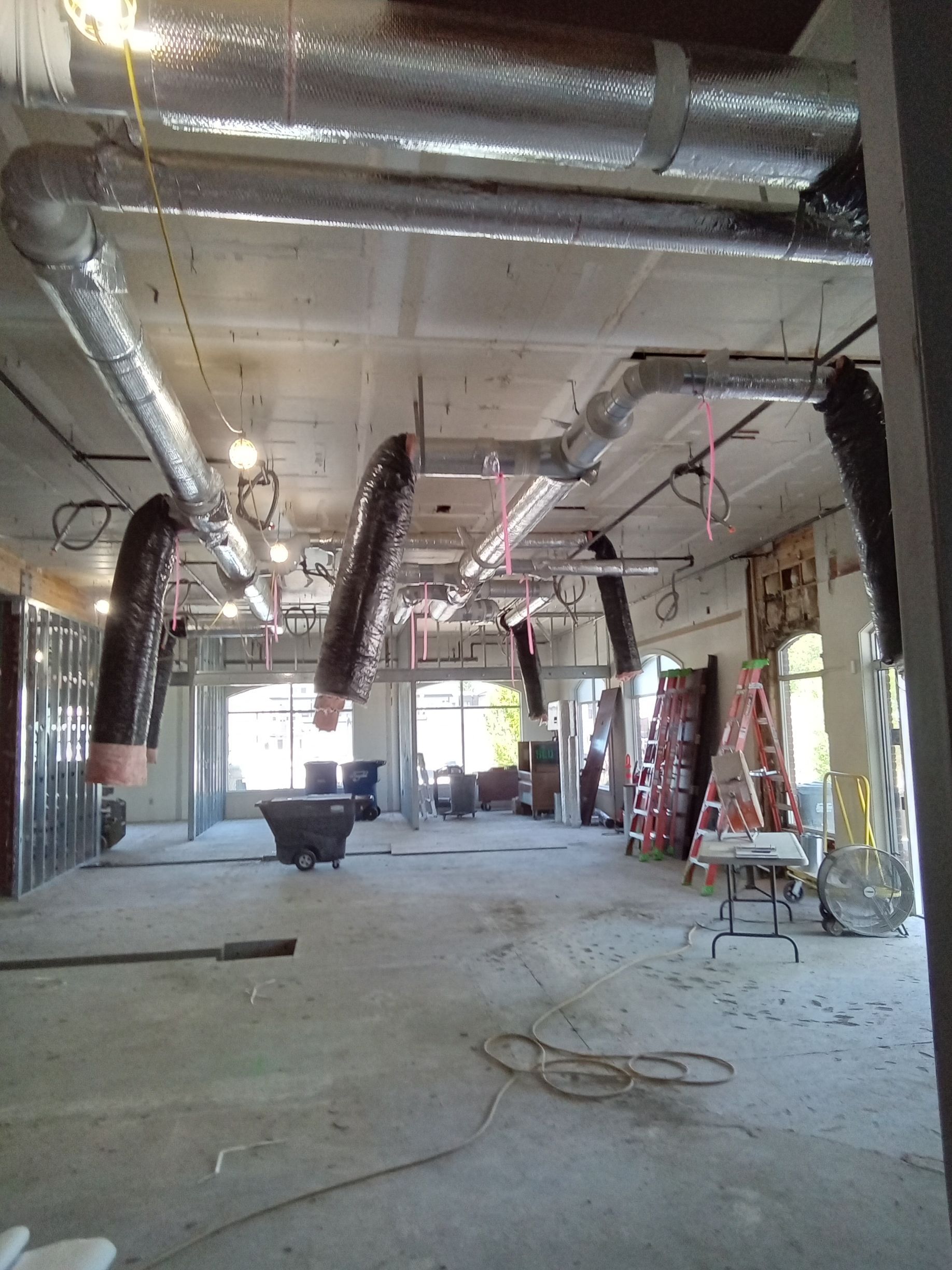 A large room with a lot of pipes hanging from the ceiling
