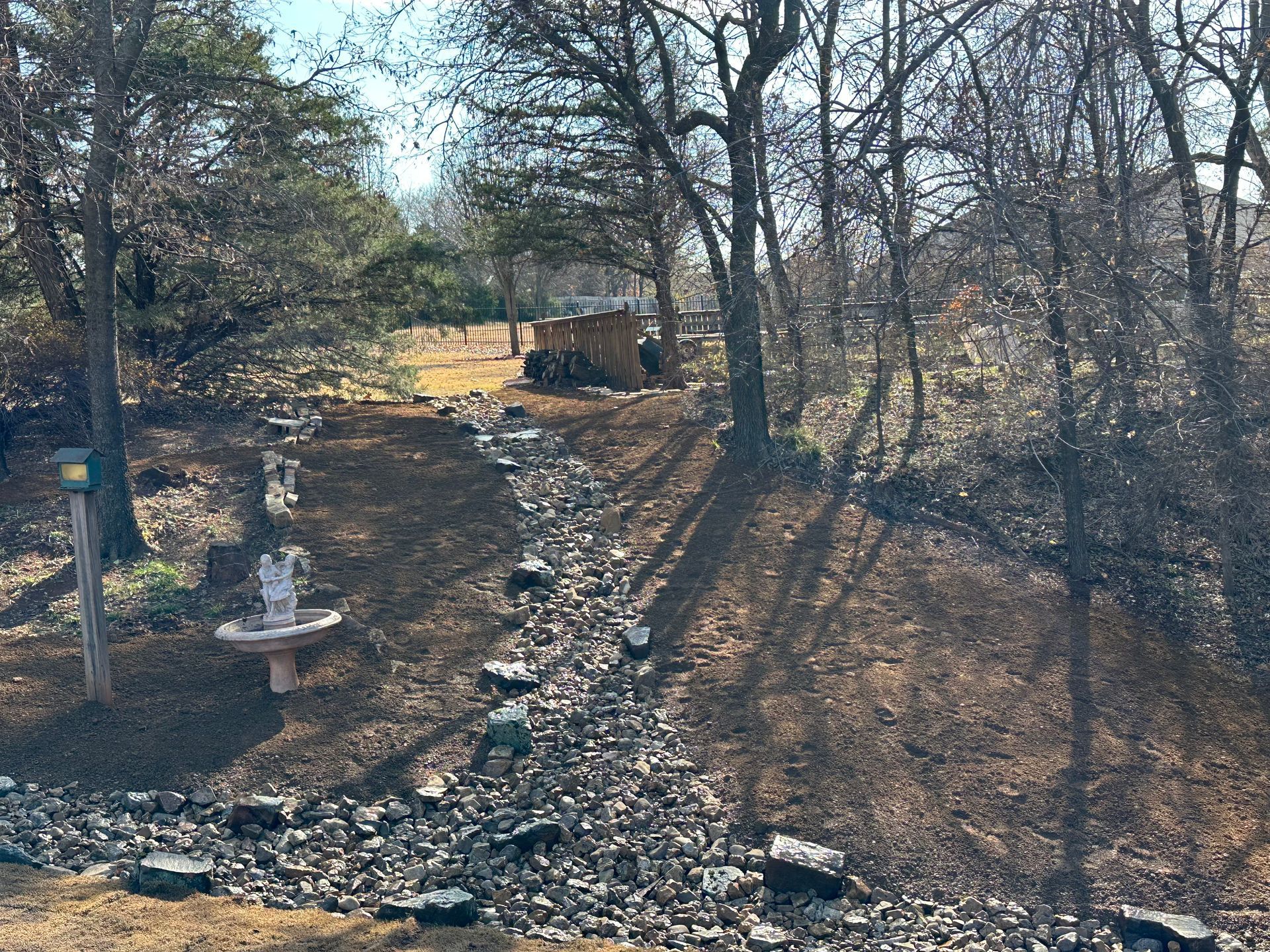 There is a fountain in the middle of the woods.