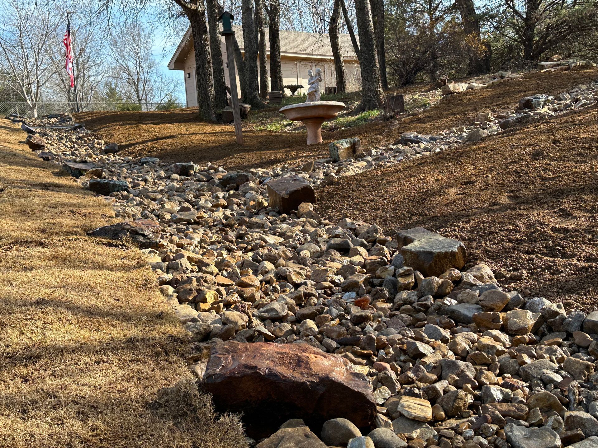 There is a picnic table in the middle of a rocky area.