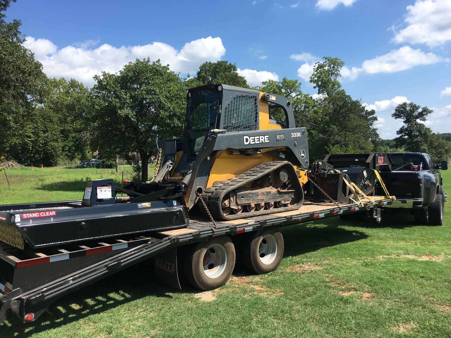 A bulldozer is sitting on top of a flatbed trailer.