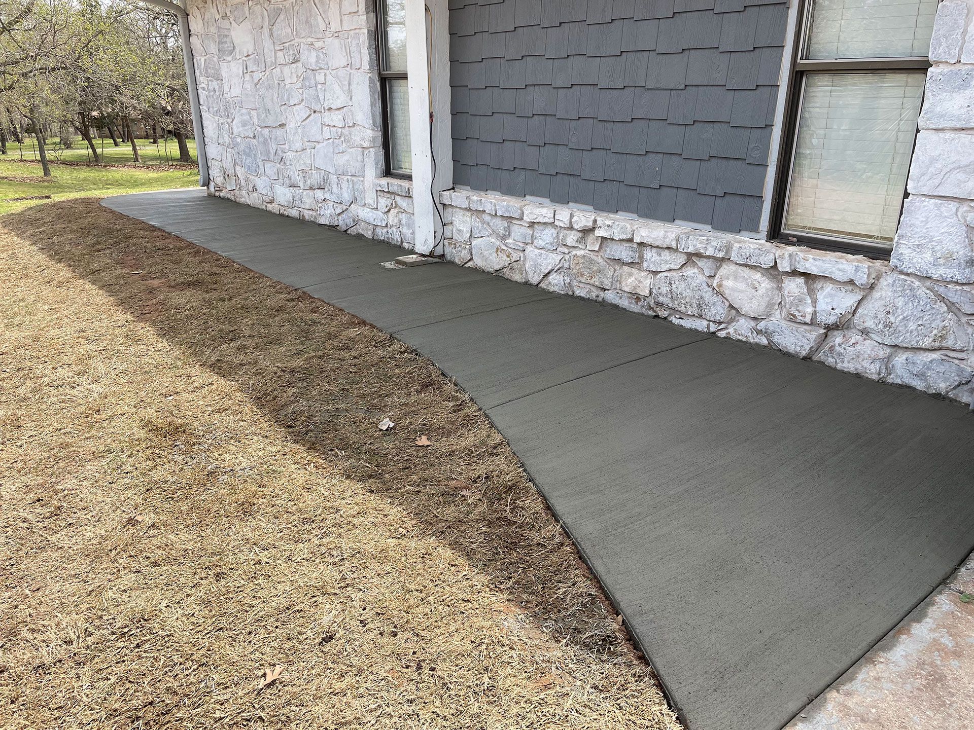 a concrete walkway is being built in front of a house