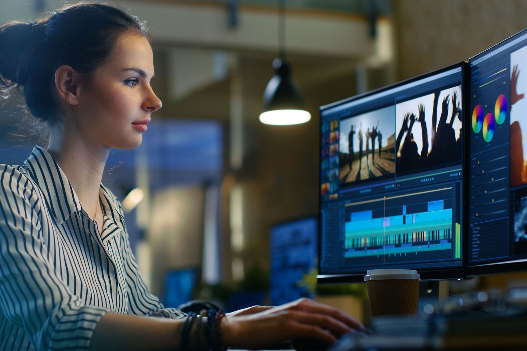 A woman is editing a video on a computer.