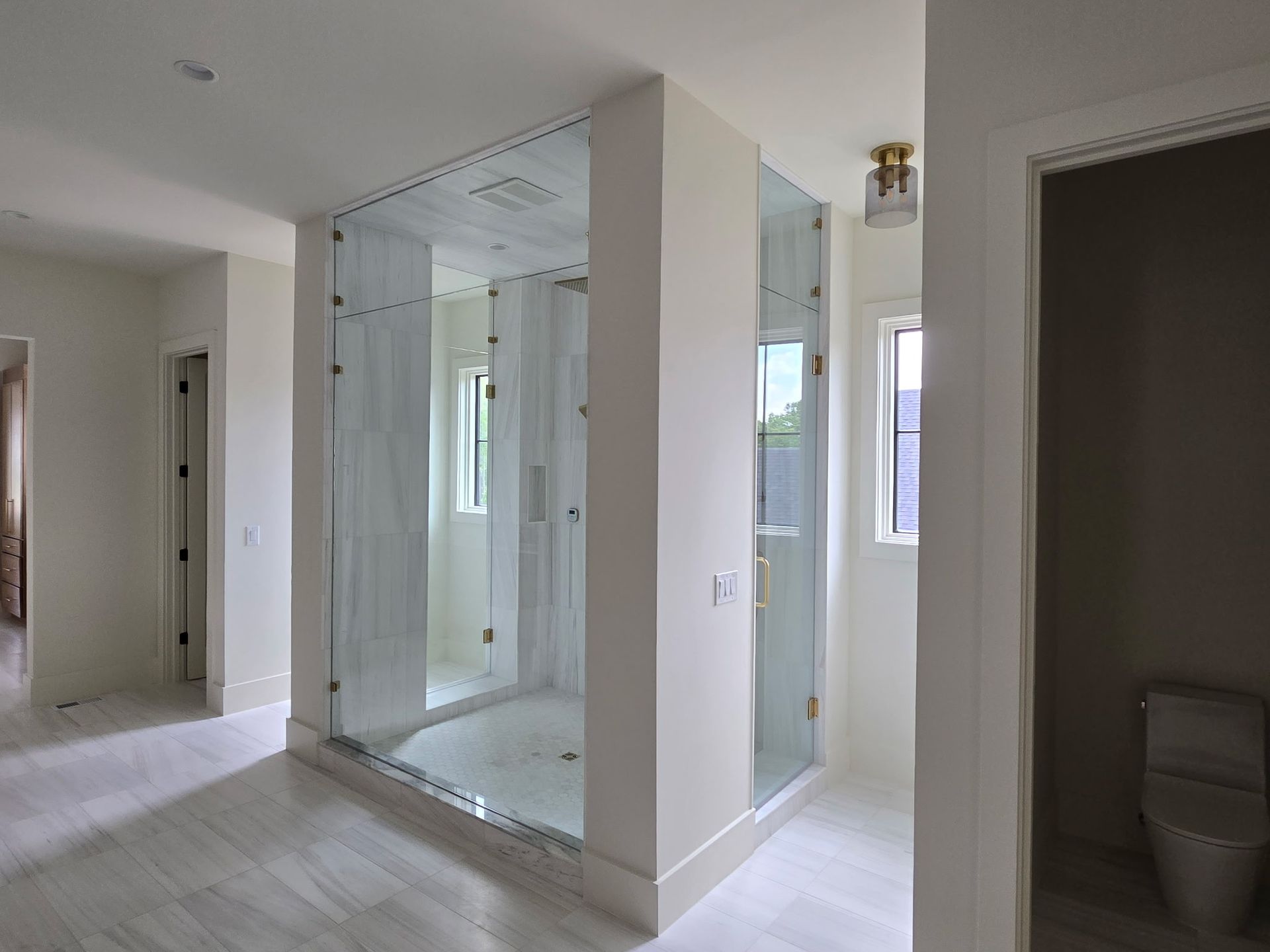 A bathroom with a walk in shower and a toilet.