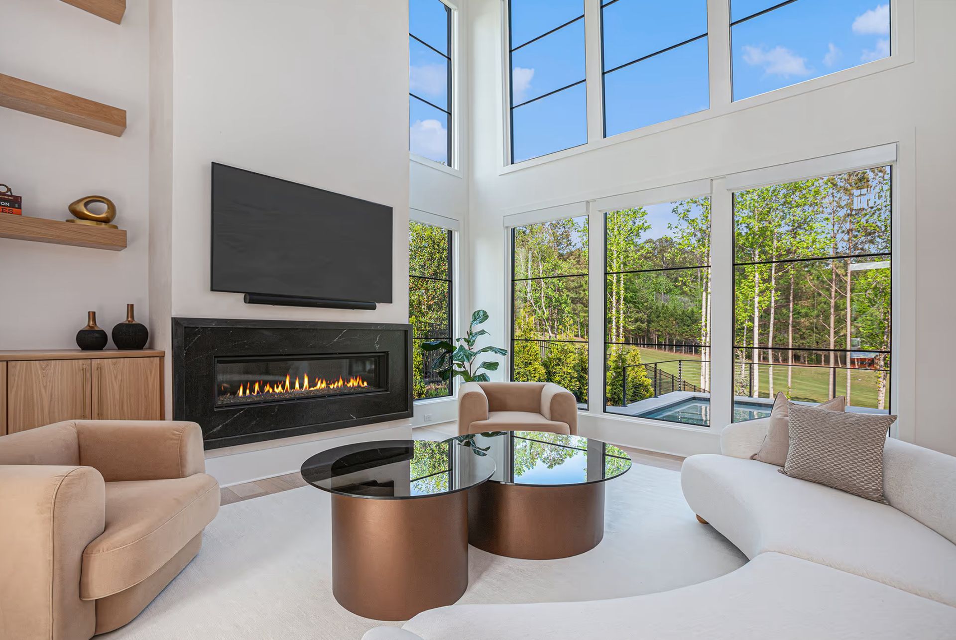 Modern living room with a fireplace, large windows, and contemporary furniture