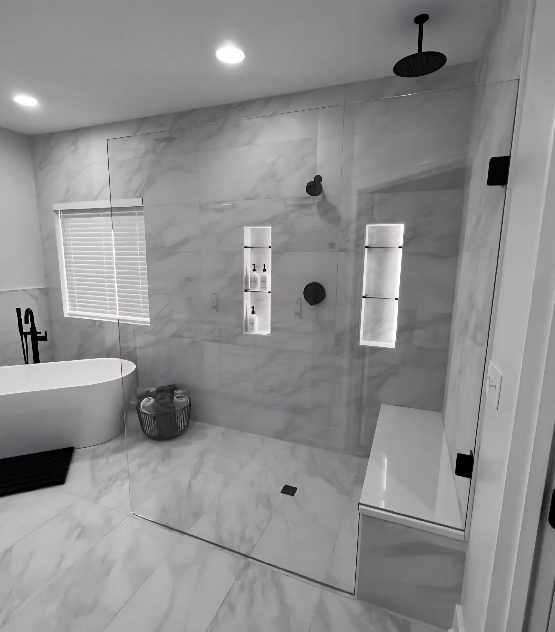 A modern bathroom with a marble shower and a soaking tub