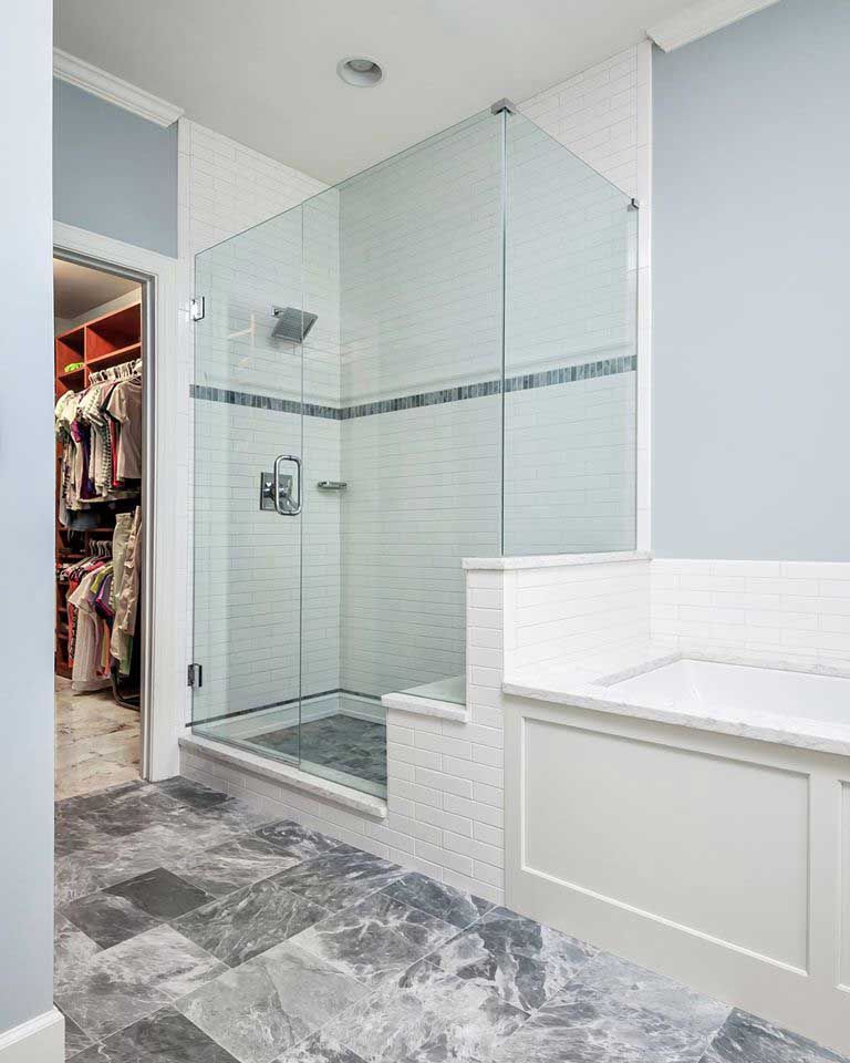 A bathroom with a walk in closet and a walk in shower.