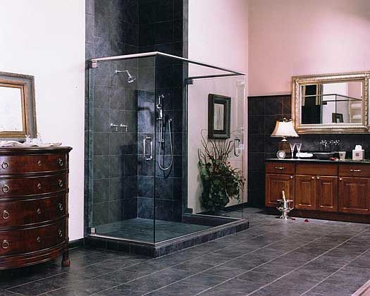 A bathroom with a walk in shower and a dresser