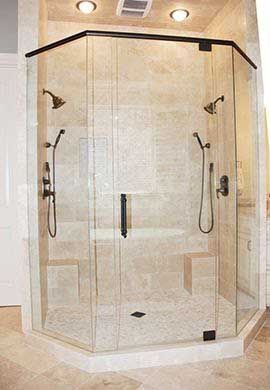 A bathroom with a walk in shower with sliding glass doors.