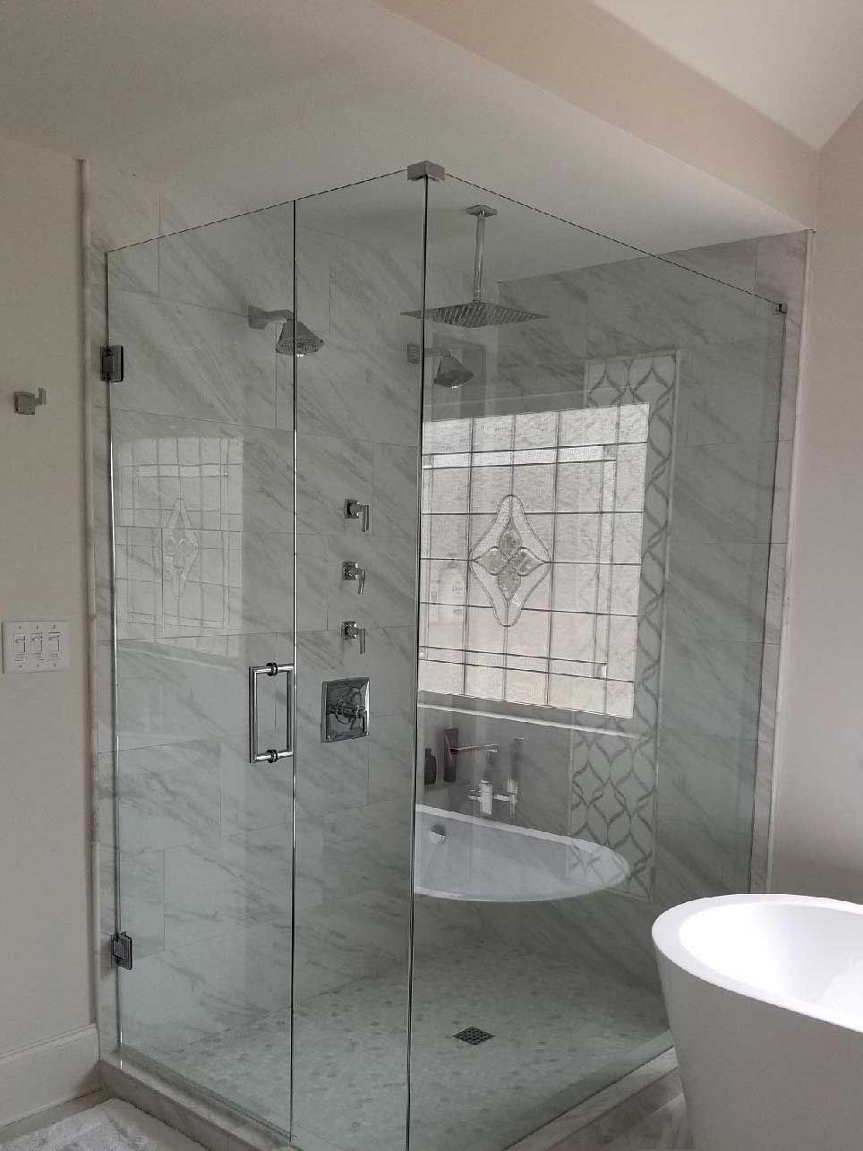 A bathroom with a walk in shower and a bathtub.