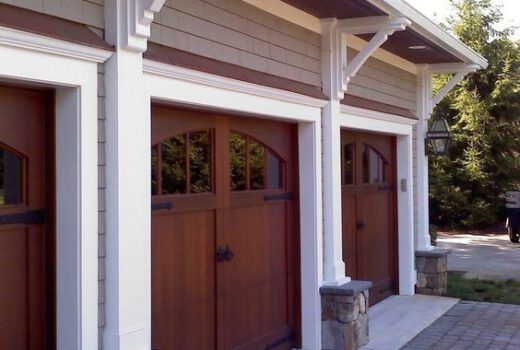 A row of wooden garage doors on a house