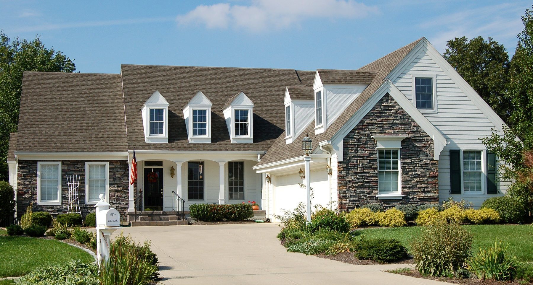 A large white house with a brown roof