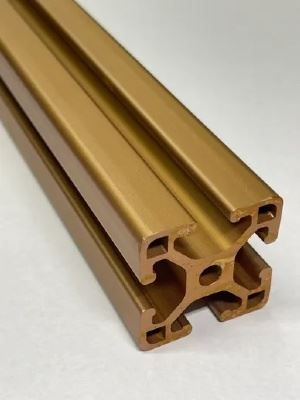 A close up of a gold metal bar on a white surface.